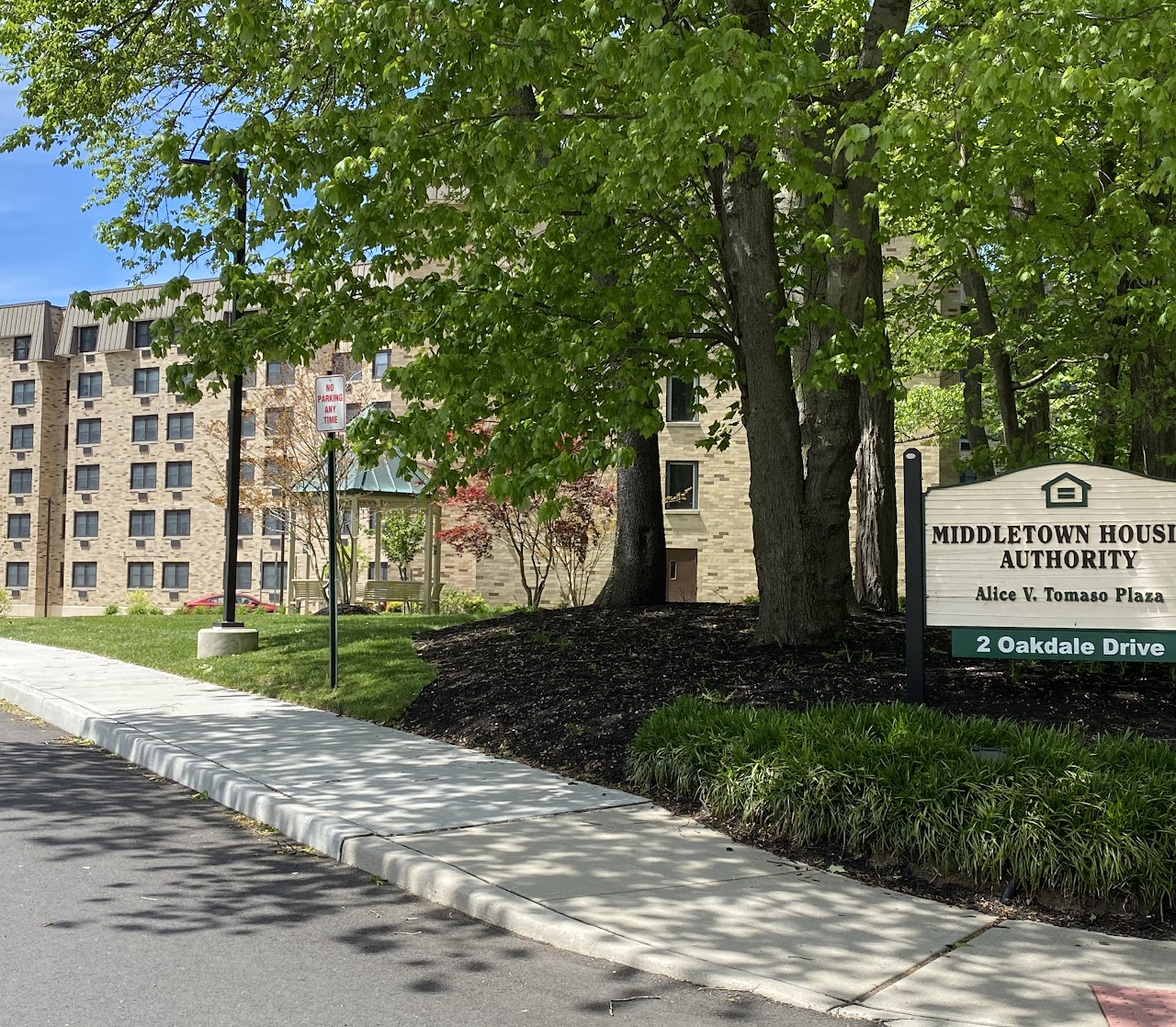 Alice V Tomaso building exterior view with yard and sign